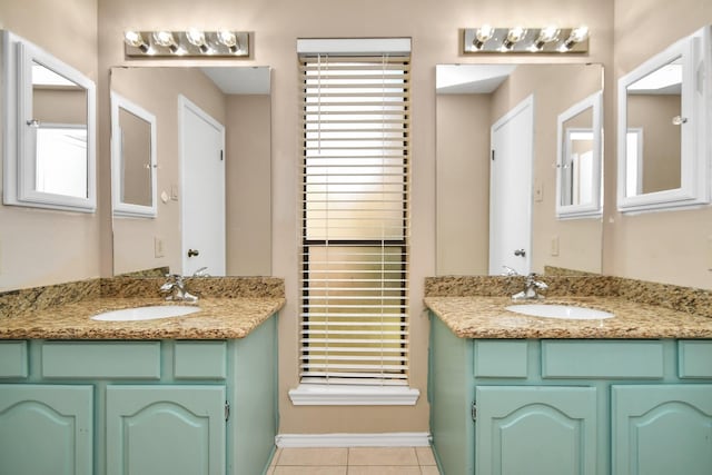 bathroom featuring tile patterned flooring, two vanities, and a sink