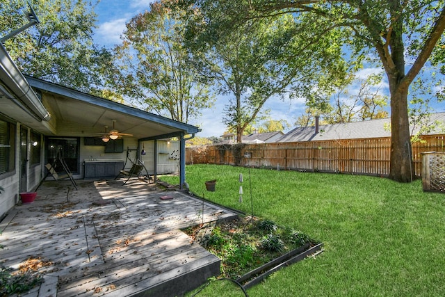 view of yard with fence private yard and ceiling fan