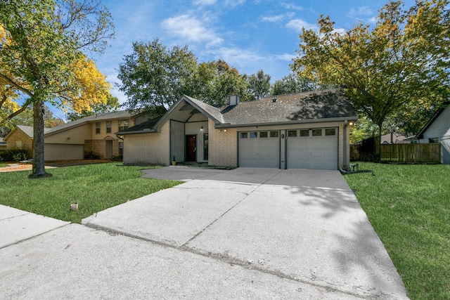 view of front of property with an attached garage, driveway, brick siding, and a front yard