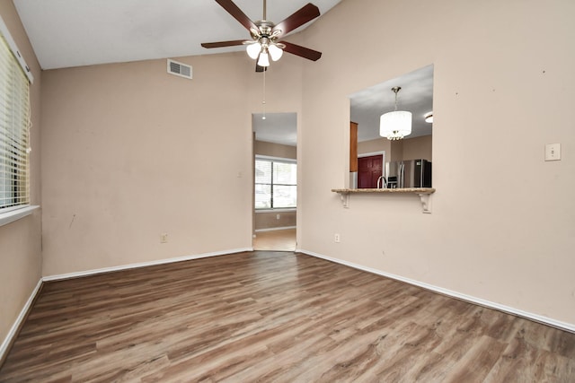 empty room featuring visible vents, baseboards, and wood finished floors