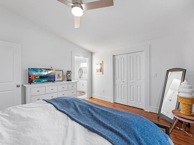 bedroom featuring baseboards, lofted ceiling, ceiling fan, ensuite bathroom, and light wood-type flooring