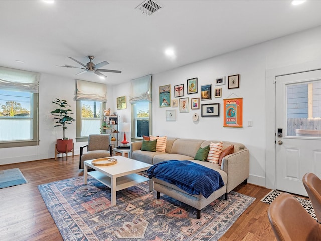 living area with recessed lighting, visible vents, a ceiling fan, wood finished floors, and baseboards