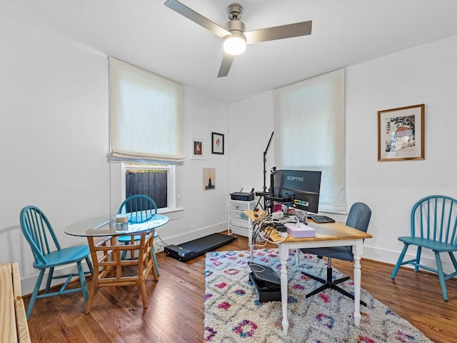 office space featuring ceiling fan, baseboards, and wood finished floors