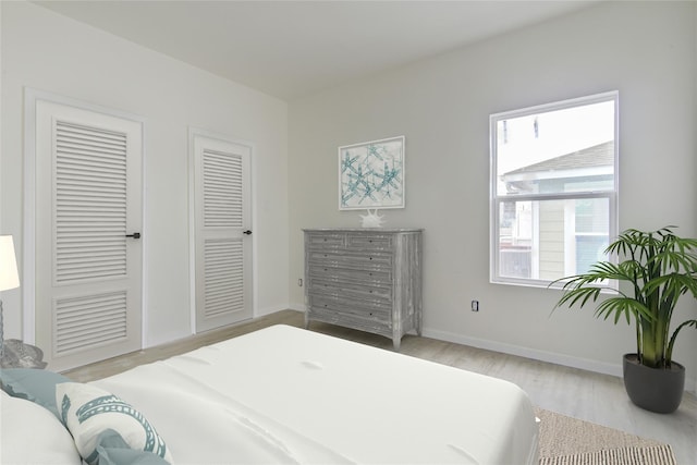 bedroom with baseboards and wood finished floors