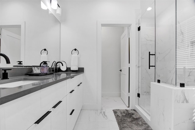 full bathroom with marble finish floor, double vanity, a sink, and a marble finish shower