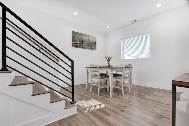 dining room featuring recessed lighting, wood finished floors, visible vents, baseboards, and stairway