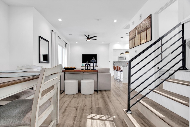 living room with recessed lighting, visible vents, ceiling fan, light wood-type flooring, and stairs