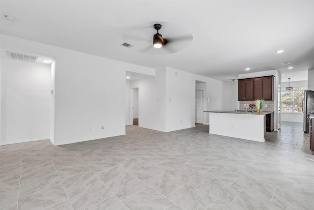 unfurnished living room featuring recessed lighting, visible vents, ceiling fan, and baseboards