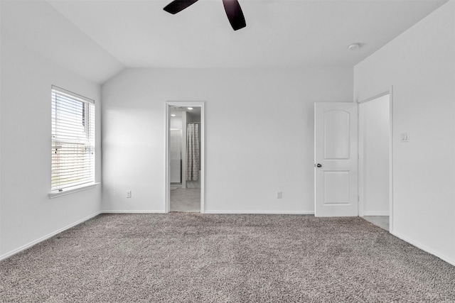 unfurnished bedroom with a ceiling fan, carpet flooring, vaulted ceiling, and ensuite bathroom