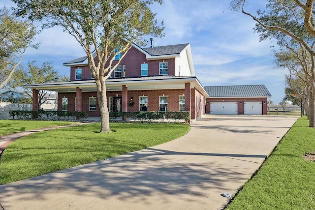 view of front of home with metal roof, a garage, brick siding, an outdoor structure, and a front lawn