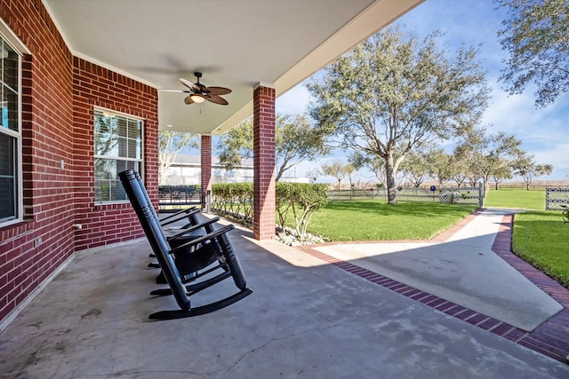 view of patio / terrace featuring fence and a ceiling fan