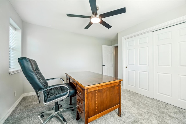 carpeted home office featuring ceiling fan and baseboards