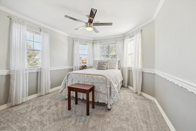 bedroom featuring a ceiling fan, light carpet, crown molding, and baseboards