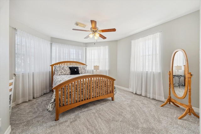 bedroom with a ceiling fan, carpet, visible vents, and baseboards