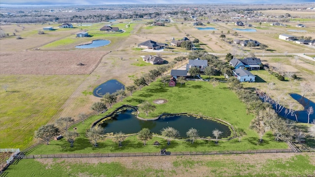 birds eye view of property featuring a water view and a rural view