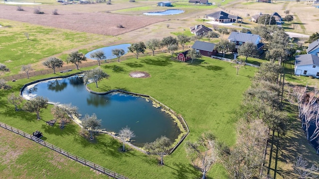 birds eye view of property with a water view and a rural view