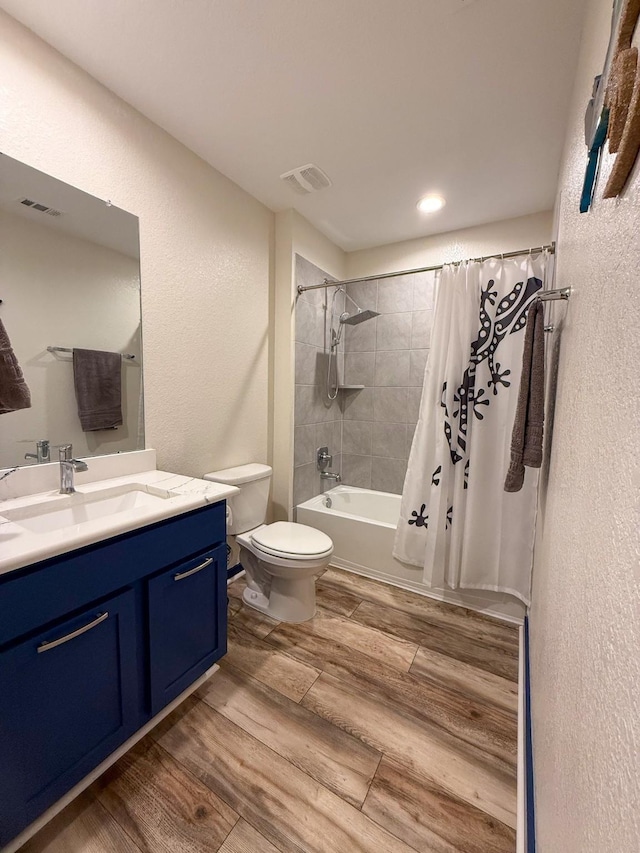 full bath with shower / bath combination with curtain, visible vents, toilet, vanity, and wood finished floors