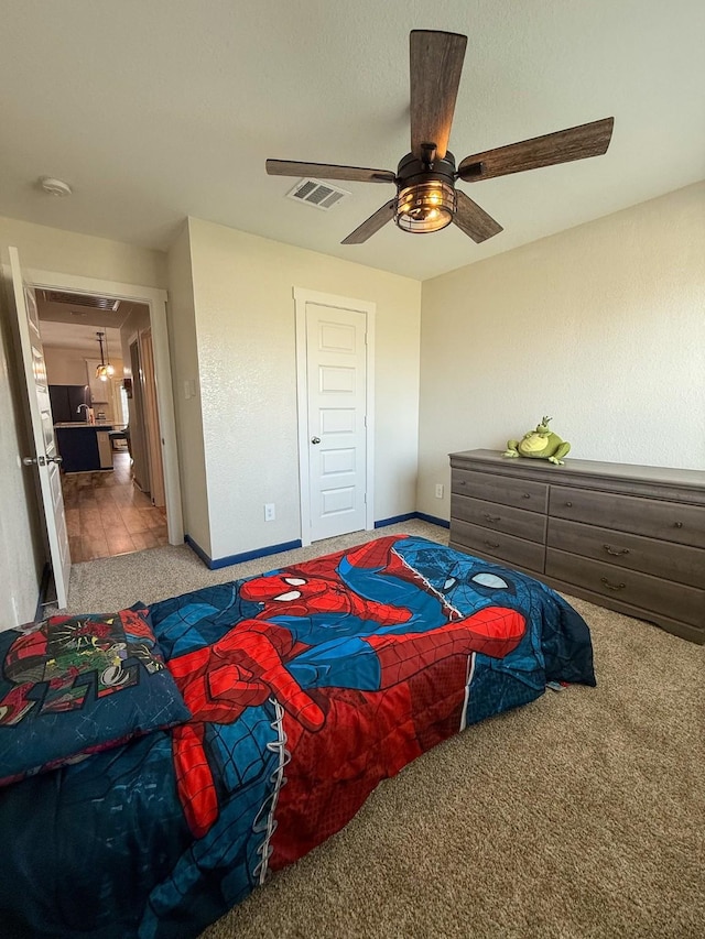 bedroom with visible vents, baseboards, ceiling fan, carpet floors, and a closet