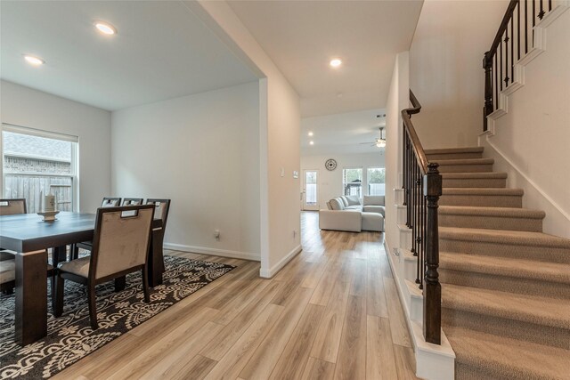 dining area featuring light wood finished floors, stairway, recessed lighting, and baseboards