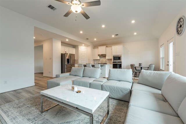 living room with visible vents, recessed lighting, light wood finished floors, baseboards, and ceiling fan