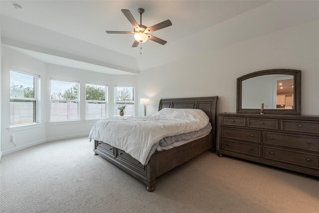 bedroom featuring baseboards, light colored carpet, lofted ceiling, and a ceiling fan