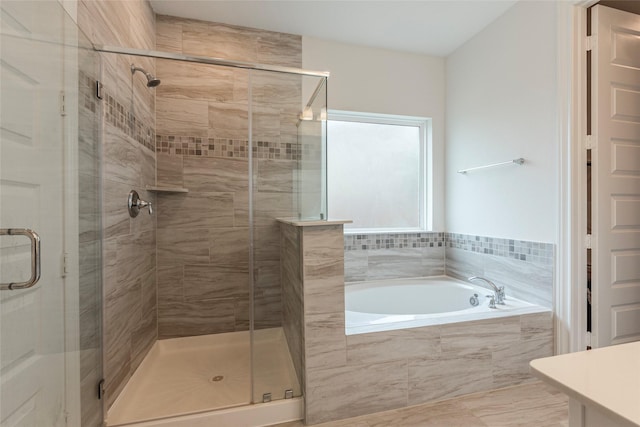 bathroom with a garden tub and a stall shower