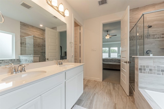 full bath with a sink, visible vents, a shower stall, and ensuite bathroom