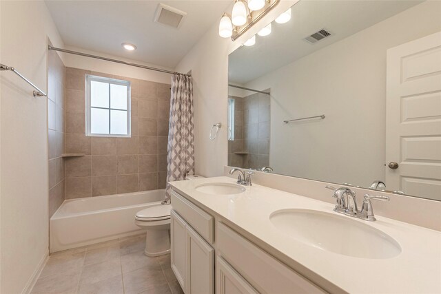 bathroom featuring a sink, visible vents, and tile patterned flooring