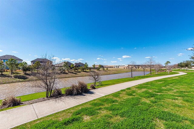 exterior space featuring a yard and a water view