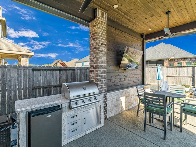 view of patio featuring outdoor dining space, area for grilling, and a fenced backyard