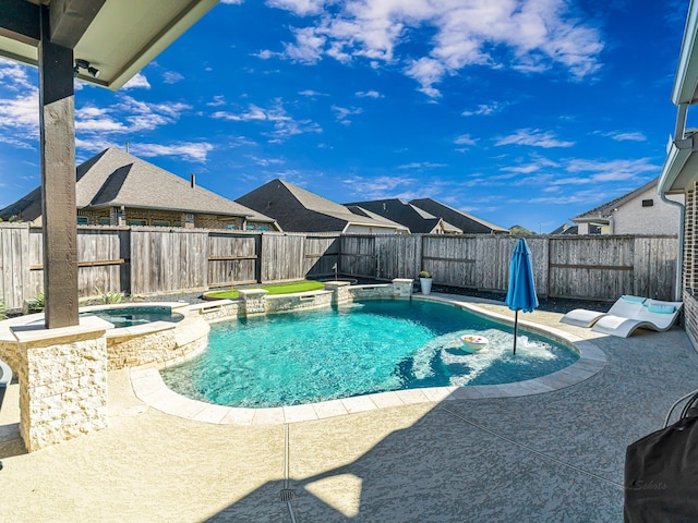 view of swimming pool featuring a patio, a fenced backyard, and a pool with connected hot tub