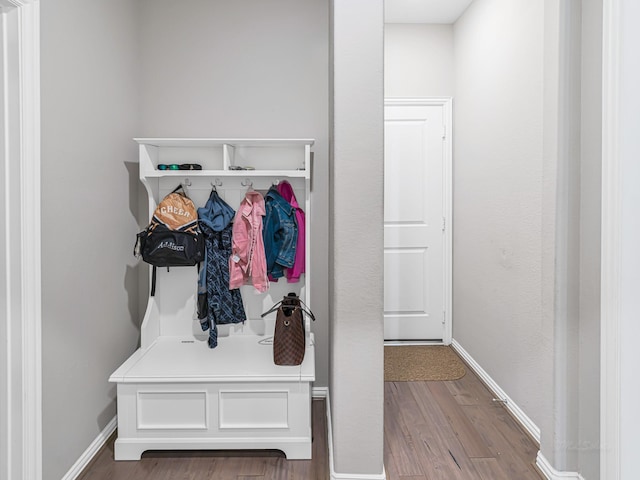 mudroom featuring baseboards and wood finished floors