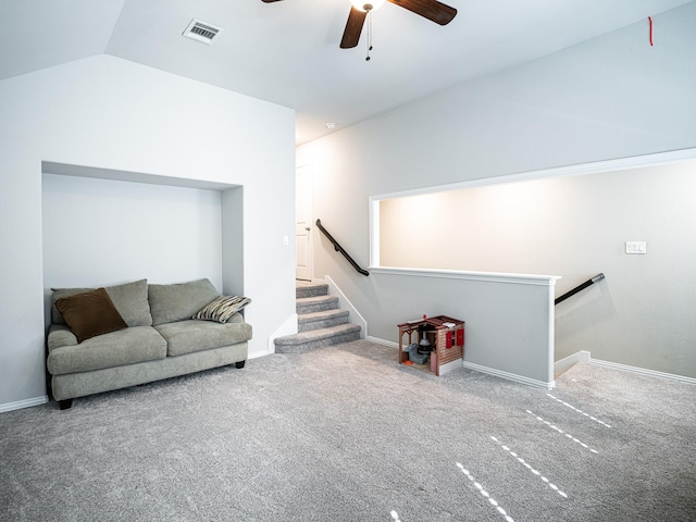 carpeted living room featuring lofted ceiling, a ceiling fan, visible vents, and baseboards