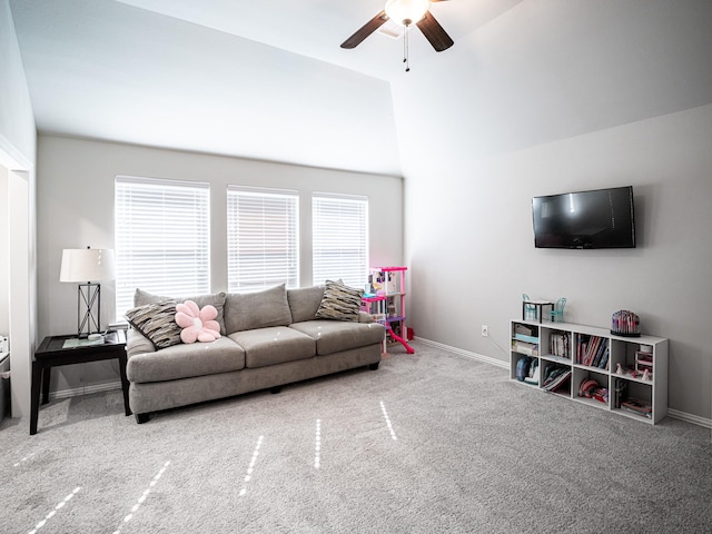 carpeted living room featuring a ceiling fan and baseboards