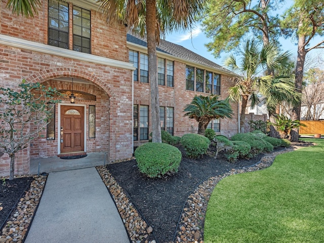 view of front of home featuring a front yard and brick siding