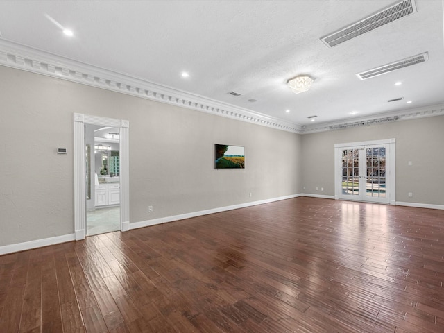 unfurnished room featuring wood-type flooring, visible vents, and french doors