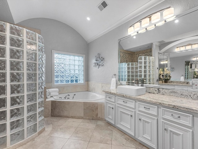 full bathroom featuring visible vents, a garden tub, walk in shower, vaulted ceiling, and vanity