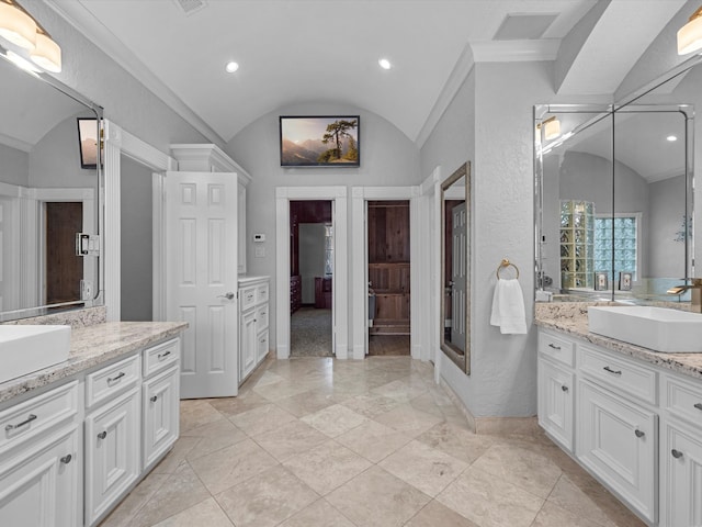 full bathroom featuring visible vents, lofted ceiling, a sink, two vanities, and recessed lighting