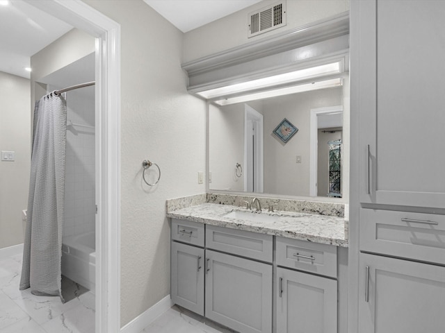 bathroom with baseboards, visible vents, marble finish floor, shower / bath combo with shower curtain, and vanity