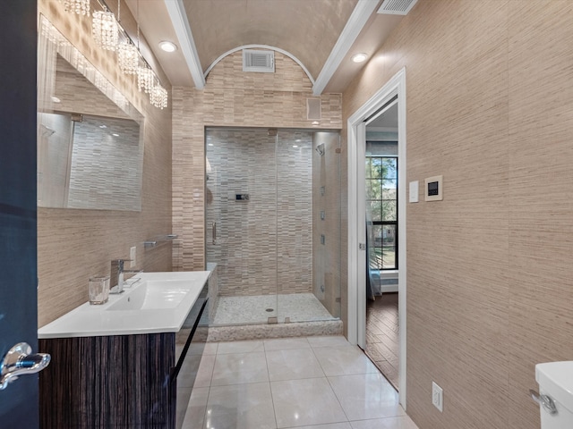 full bathroom featuring a stall shower, lofted ceiling, tile patterned flooring, vanity, and tile walls