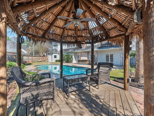 view of swimming pool with a fenced in pool, a ceiling fan, a gazebo, fence, and a wooden deck