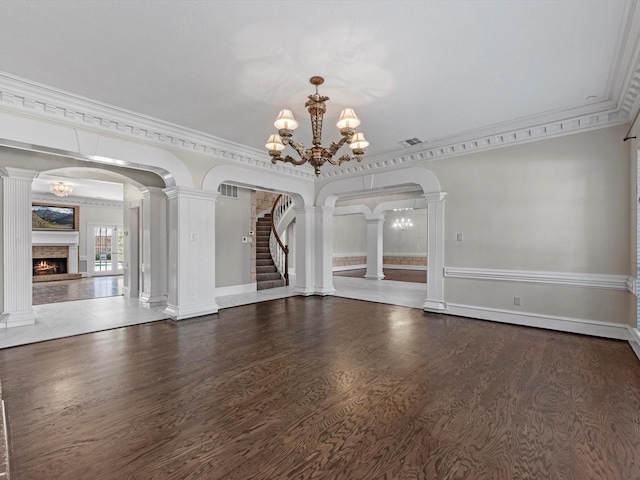 7714 Hertfordshire Dr, Spring, TX 77379 - unfurnished dining area with a warm lit fireplace, ornamental molding, a chandelier, baseboards, and wood finished floors