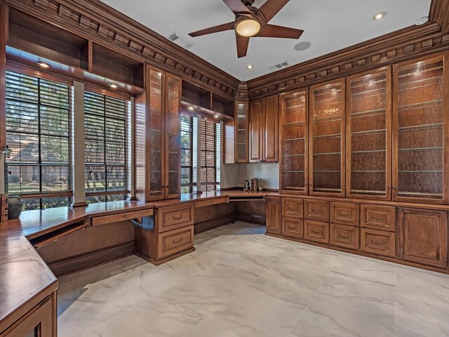 office with marble finish floor, a ceiling fan, visible vents, and built in desk