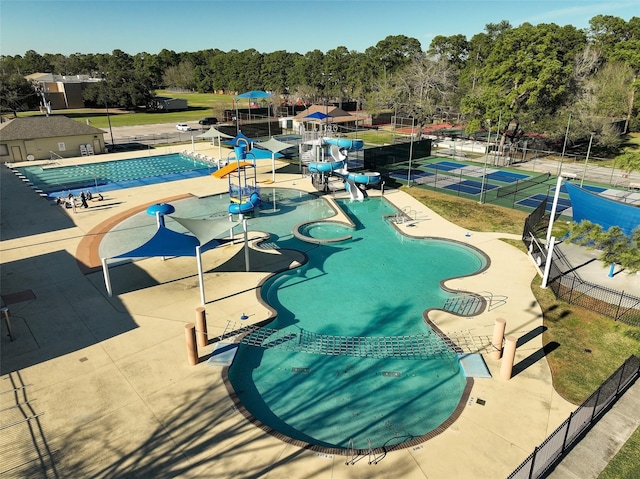 pool with fence, a water play area, and a water slide