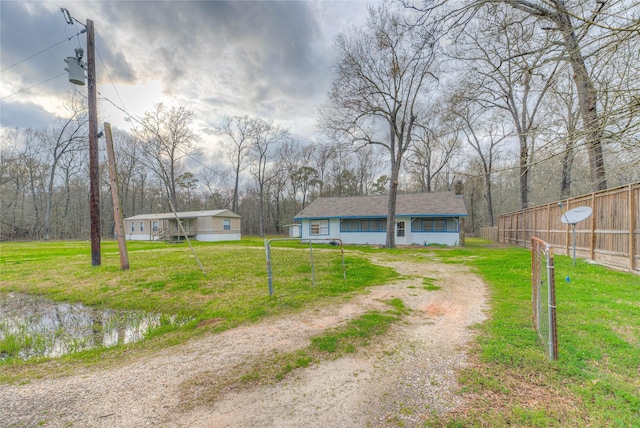 view of road featuring driveway and a gated entry