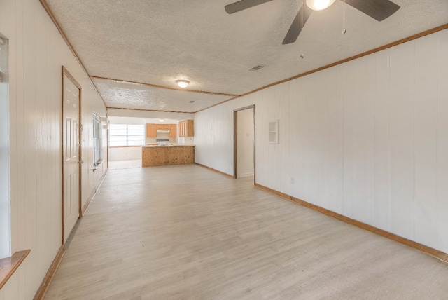 interior space with visible vents, crown molding, light wood-style flooring, and a textured ceiling