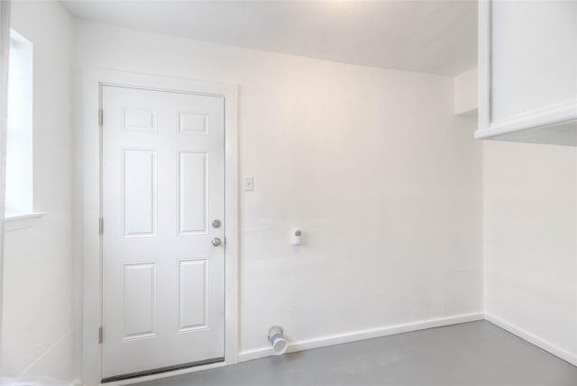 interior space featuring finished concrete floors and baseboards