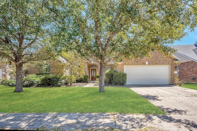 obstructed view of property with driveway, a front lawn, and an attached garage