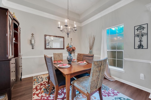 dining room with a healthy amount of sunlight, baseboards, dark wood-style floors, an inviting chandelier, and crown molding