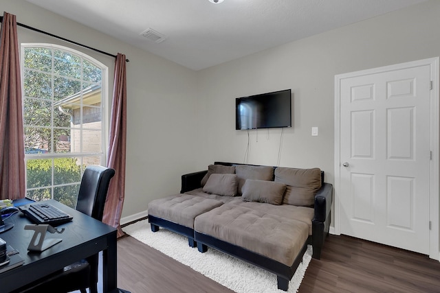 bedroom with dark wood-type flooring, visible vents, and baseboards